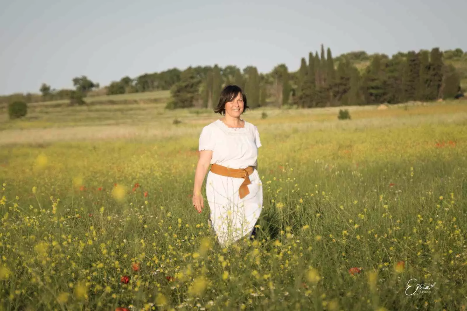Portrait de Karine Bonneau Hernandez dans un champ fleuri, au cœur de la nature.